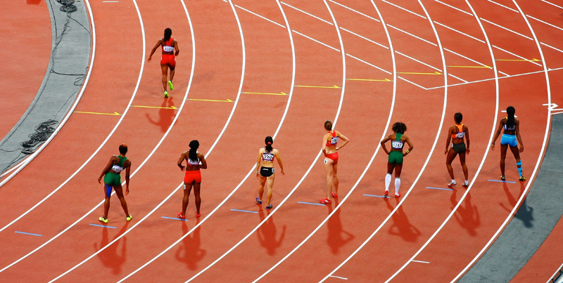 Female runners lining up to start a race at the Olympic Games