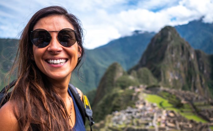 A girl enjoying spiritual travel at Machu Picchu in Peru